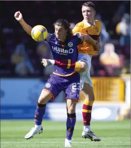  ??  ?? Dundee United’s Ian Harkes holds off David Turnbull