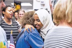  ?? JENN ACKERMAN/NEW YORK TIMES ?? Supporters greet U.S. Rep. Ilhan Omar, D-Minn., center right, at Minneapoli­sSt. Paul Internatio­nal Airport on Thursday. ‘What I’m going to be busy doing is uplifting people, and making sure they understand: Here in this country we are all Americans,’ Omar said in response to a ‘send her back’ chant that broke out at a rally Wednesday night when President Donald Trump railed against the Somali-born congresswo­man.