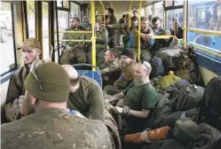  ?? AP ?? Ukrainian fighters sit aboard a bus near a prison in Olyonivka, Ukraine, in territory controlled by the separatist Donetsk People’s Republic after being evacuated from the Azovstal steel plant in Mariupol on Tuesday. The sprawling plant was the soldiers’ last redoubt in the city.