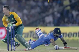  ?? PICTURE: REUTERS ?? India's Virat Kohli dives to make the crease as he is run out by South Africa's AB de Villiers during their second Twenty20 cricket match in Cuttack, India.