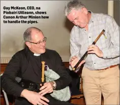  ??  ?? Gay McKeon, CEO, na Píobairí Uilleann, shows Canon Arthur Minion how to handle the pipes.