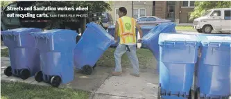  ?? SUN-TIMES FILE PHOTO ?? Streets and Sanitation workers wheel out recycling carts.