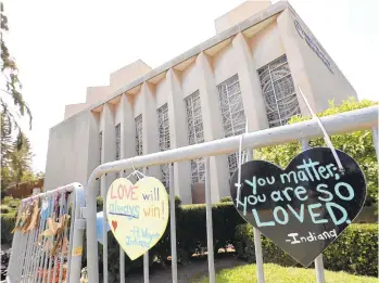  ?? GENE J. PUSKAR/AP ?? Signs hang on a fence surroundin­g the Tree of Life synagogue in Pittsburgh in 2019. When a gunman opened fire on the morning of Oct. 27, 2018, 11 people were killed between the three congregati­ons holding services inside the building — Tree of Life/Or L’Simcha, New Light and Dor Hadash — and six others, including four Pittsburgh police officers, were injured.