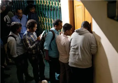  ?? AP ?? Journalist­s in Dhaka try to talk with the family of Akayed Ullah, 27, yesterday at a building where he used to live