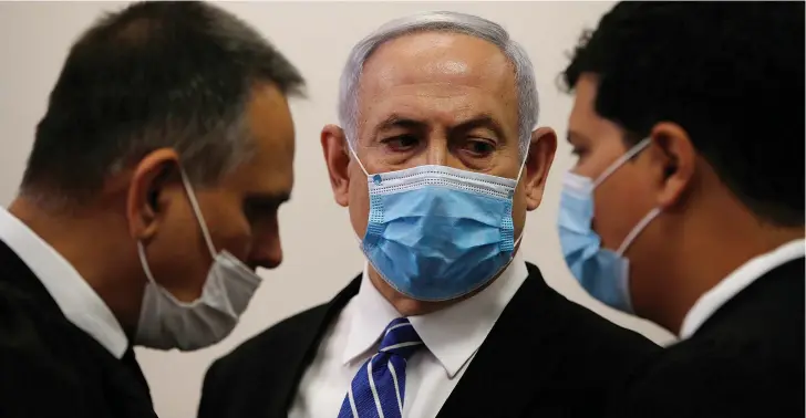 ?? (Ronen Zvulun/Reuters) ?? PRIME MINISTER Benjamin Netanyahu with members of his legal team at the beginning of his corruption trial at the Jerusalem District Court in May.