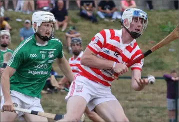  ??  ?? James Lawlor of Ferns St. Aidan’s gets to the ball ahead of Pádraig Doyle (Naomh Eanna).