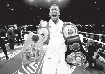  ??  ?? Anthony Joshua celebrates with the belts after winning the fight against Joseph Parker of New Zealand at the Principali­ty Stadium, Cardiff, Britain in this March 31 file photo. — Reuters photo