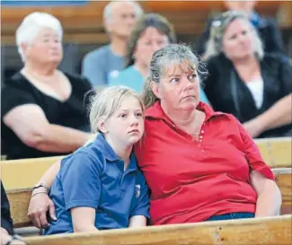  ?? Photo: DONSCOTT/FAIRFAX ?? End of the line: Mary Moffitt and her daughter Lauren, 12, react to news that Branston Intermedia­te will close in January.
