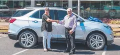  ??  ?? LAST SALE: Judith Spagnolo of Innisfail takes the keys to a 2020 Equinox LTZ-V SUV from Cairns car dealer Richard Ireland.