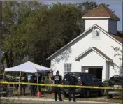  ?? AMERICAN-STATESMAN VIA AP ?? Law enforcemen­t officials work at the scene of a fatal shooting at the First Baptist Church in Sutherland Springs, Texas on Sunday. NICK WAGNER/AUSTIN