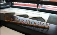  ?? LAUREN HALLIGAN - MEDIANEWS GROUP ?? A newly engraved wooden sign is made at Saratoga Custom Engraving.
