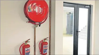  ?? Picture: ALAN EASON ?? SOUND THE ALARM: An example of a fire reel and extinguish­er set up which has been serviced by legitimate servicers