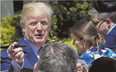  ?? AP PHOTO ?? TURMOIL: President Trump celebrates on the South Lawn for ‘Bring Our Daughters and Sons to Work Day’ at the White House in Washington yesterday.