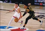  ?? MARK J. TERRILL — THE ASSOCIATED PRESS ?? The Miami Heat’s Tyler Herro, left, and the Los Angeles Lakers’ Danny Green, right, compete for control of a loose ball during the second half of Game 2 of the NBA Finals on Friday in Lake Buena Vista, Fla.