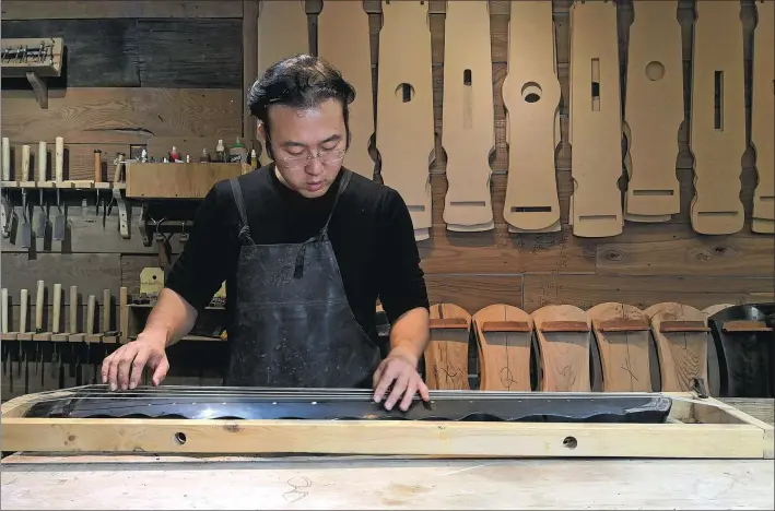  ??  ?? Top row: Making guqin takes patience and care. Above: Experience­d guqin makers like Sui Yiyang should know the sweet spot for the tuning.