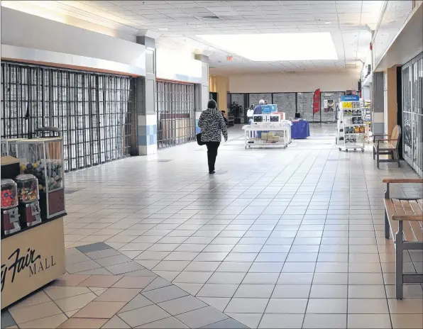  ?? SARA ERICSSON PHOTOS ?? A lone person walks down hallway past several stores for lease at County Fair Mall in New Minas, where the NSLC store now sells legal cannabis.