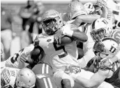  ?? STREETER LECKA/GETTY IMAGES ?? Jacques Patrick’s bruising running style has helped the Seminoles develop their running game this season.