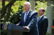  ?? AP PHOTO/EVAN VUCCI ?? Secretary of Health and Human Services Alex Azar looks on as President Donald Trump speaks during an event about prescripti­on drug prices in the Rose Garden of the White House on Friday in Washington.