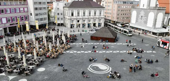  ?? Foto: Silvio Wyszengrad ?? Der Rathauspla­tz am Freitagnac­hmittag: Wenn die Sonne scheint, sind sowohl Straßencaf­és als auch der Platz selbst gut frequentie­rt. Die Menschen sitzen auf Stühlen, Bänken oder einfach nur auf dem Boden. Eigentlich ist das auch so gewünscht, dennoch...