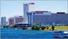  ?? PHOTO BY ERNEST FODE ?? The Riverside Resort Casino and other Laughlin hotels along the Colorado River. On the right a tour boat is seen sailing upstream to the Davis Dam.