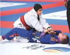  ?? Abdul Rahman/Gulf News ?? Winner Aisha Abubaker Al Hashmi of the UAE (above) and Al Yazyeh Al Blooshi (UAE) are seen in action in the girls finals teen 40kg category at Zayed Sports City yesterday.