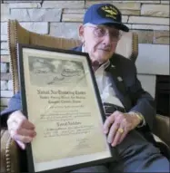  ?? JOHN SEEWER — THE ASSOCIATED PRESS ?? In this Wednesday photo, World War II veteran Bob Barger poses with his Naval flight school certificat­e in Toledo, Ohio. Barger is set to graduate from the University of Toledo after a review of his transcript­s showed he completed enough classes in the...