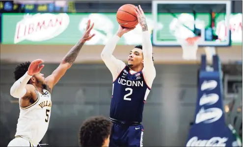  ?? Matt Slocum / Associated Press ?? UConn’s James Bouknight (2) goes up for a shot against Villanova’s Justin Moore during the second half on Saturday.