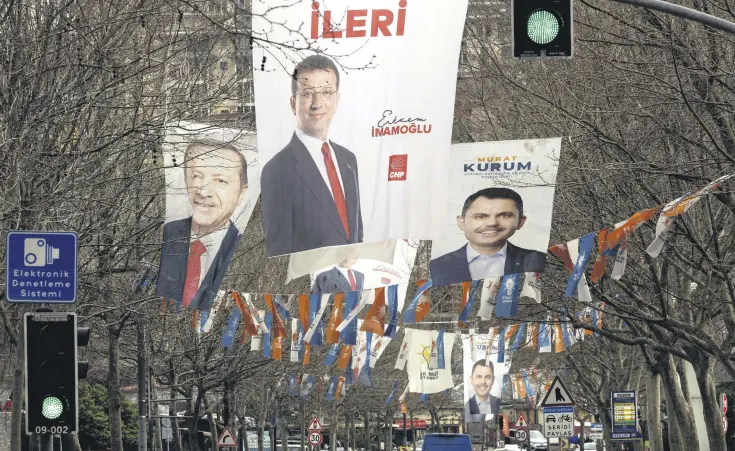  ?? ?? Election banners of Murat Kurum (R), mayoral candidate of the ruling AK Party, Istanbul’s mayor Ekrem İmamoglu (C) and President Recep Tayyip Erdoğan hang along a street ahead of the local elections in Istanbul, Türkiye, March 28, 2024.