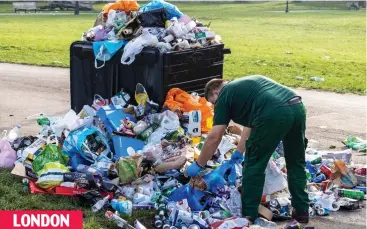  ??  ?? Hill hell: Weary worker picks up rubbish strewn around a stuffed bin in Primrose Hill