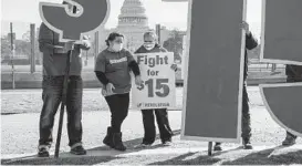  ?? J. SCOTT APPLEWHITE/AP ?? Activists appeal for a $15 minimum wage last week near the U.S. Capitol. The House has passed a $1.9 trillion COVID-19 relief bill that includes a provision that would gradually hike the federal minimum wage to $15 an hour.