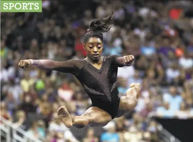  ?? Jamie Squire / Getty Images ?? Simone Biles competes on floor exercise during the U.S. Gymnastics Championsh­ips at the Sprint Center in Kansas City, Mo. She nailed a tripletwis­ting doubleflip, a move she didn’t quite complete Friday.
