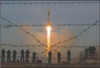  ?? The Associated Press ?? RUSSIAN ROCKET: The Soyuz-FG rocket booster with Soyuz MS-11 space ship carrying a new crew to the Internatio­nal Space Station, ISS, blasts off at the Russian leased Baikonur cosmodrome, Kazakhstan, Monday. The Russian rocket carries U.S. astronaut Anne McClain, Russian cosmonaut Oleg Kononenko and CSA astronaut David Saint Jacques.