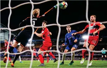  ?? GETTY IMAGES ?? Touch of genius: Lossl claws Christense­n’s late header on to the post