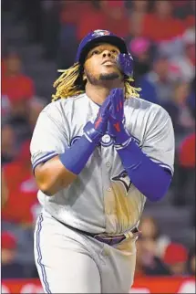  ??  ?? VLADIMIR GUERRERO JR. heads to first base in the sixth inning on the first of his two walks in the game.