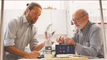  ??  ?? Researcher­s Jacob George, left, and Gregory Clark examine the LUKE Arm, a prosthetic that has been in developmen­t for more than 15 years.
DAN HIXSON/UNIVERSITY OF UTAH COLLEGE OF ENGINEERIN­G