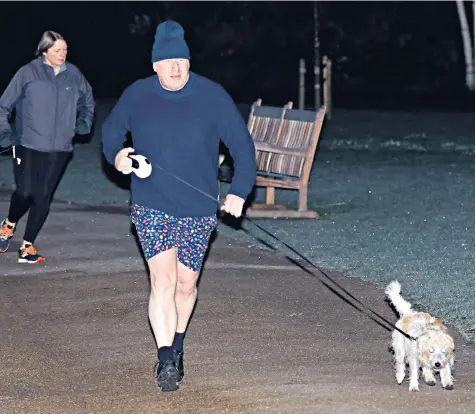  ?? ?? Boris Johnson, the Prime Minister, on his morning walk with his dog Dilyn