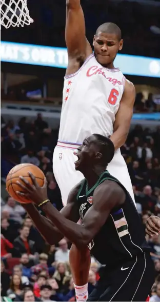  ?? | NAMY. HUH/ AP ?? The Bulls’ Cristiano Felicio hangs overBucks forward ThonMaker in the first half Friday.