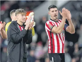  ?? ?? Sunderland’s Jack Clarke and Danny Batth applaud the fans.