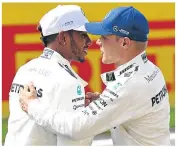  ??  ?? ■
Lewis Hamilton celebrates with team-mate Valtteri Bottas yesterday.