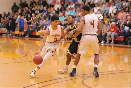  ?? PHOTO COURTESY OF CRAIG FRY/AWC CAMPUS PHOTOGRAPH­ER ?? ARIZONA WESTERN’S DARYL ADAMS (3) DRIBBLES PAST a Central Arizona defender and his teammate setting the pick, Lamont Traylor (4), during the Region I semifinals of the 2016-17 season against Central Arizona on March 4. Adams and Traylor return to the...