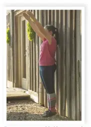  ??  ?? Engage your core with this easy standing exercise. Standing as close to a wall as you can, tuck your tailbone under you, then slowly bring your arms up in front of you.