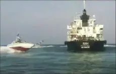  ?? Iranian state TV via AP ?? This undated photo shows the Panamanian- flagged oil tanker MT Riah surrounded by Iranian Revolution­ary Guard vessels. Iran said Thursday that its Revolution­ary Guard seized a foreign oil tanker and its crew of 12 for smuggling fuel out of the country.
