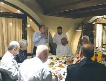  ??  ?? ISLAMIC MOVEMENT chief Raed Salah (right, rear) listens to Ambassador Kemal Okem during an Iftar dinner at the Turkish Embassy in Tel Aviv last week. (Twitter)