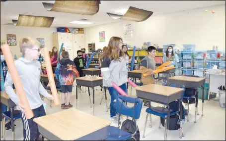  ?? RACHEL DICKERSON/MCDONALD COUNTY PRESS ?? Students in one of Stephana Wilkerson’s music classes at Southwest City Elementary participat­e in “cardio desk drumming.” Art and music teachers in the school district have changed from having grades K through 6 visit them in their classrooms to traveling around to the various classrooms due to the covid-19 pandemic.