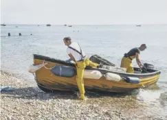  ??  ?? Beaching the tender for unloading