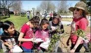  ?? FILE PHOTO/DAVID GOTTSCHALK ?? Willa Thomason, farm assistant at Apple Seeds Teaching Farm in Gulley Park, works in April with students of Monitor Elementary School in Fayettevil­le. The “Picnic on the Farm” on June 3 will help support the group’s programs.