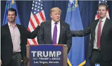  ?? ETHAN MILLER, GETTY IMAGES/FILES ?? Donald Jr., left, and Eric, right, give their father a pat following Donald Trump’s Nevada caucuses wins.