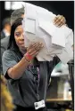  ?? AP/ALASTAIR GRANT ?? An election worker prepares to count ballots Thursday in Maidenhead, England.