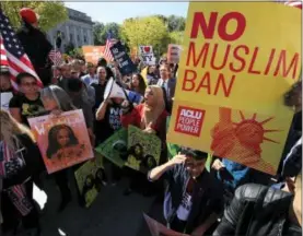  ?? THE ASSOCIATED PRESS ?? In this file photo, protesters gather at a rally in Washington. The Supreme Court is allowing the Trump administra­tion to fully enforce a ban on travel to the United States by residents of six mostly Muslim countries. The justices say in an order on...