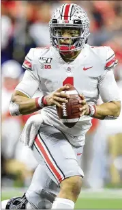  ?? ANDY LYONS / GETTY IMAGES ?? Buckeyes QB Justin Fields committed first to Penn State but chose Georgia and spent last season backing up Jake Fromm. Fields transferre­d to Ohio State and this season has proved worthy of the hype.